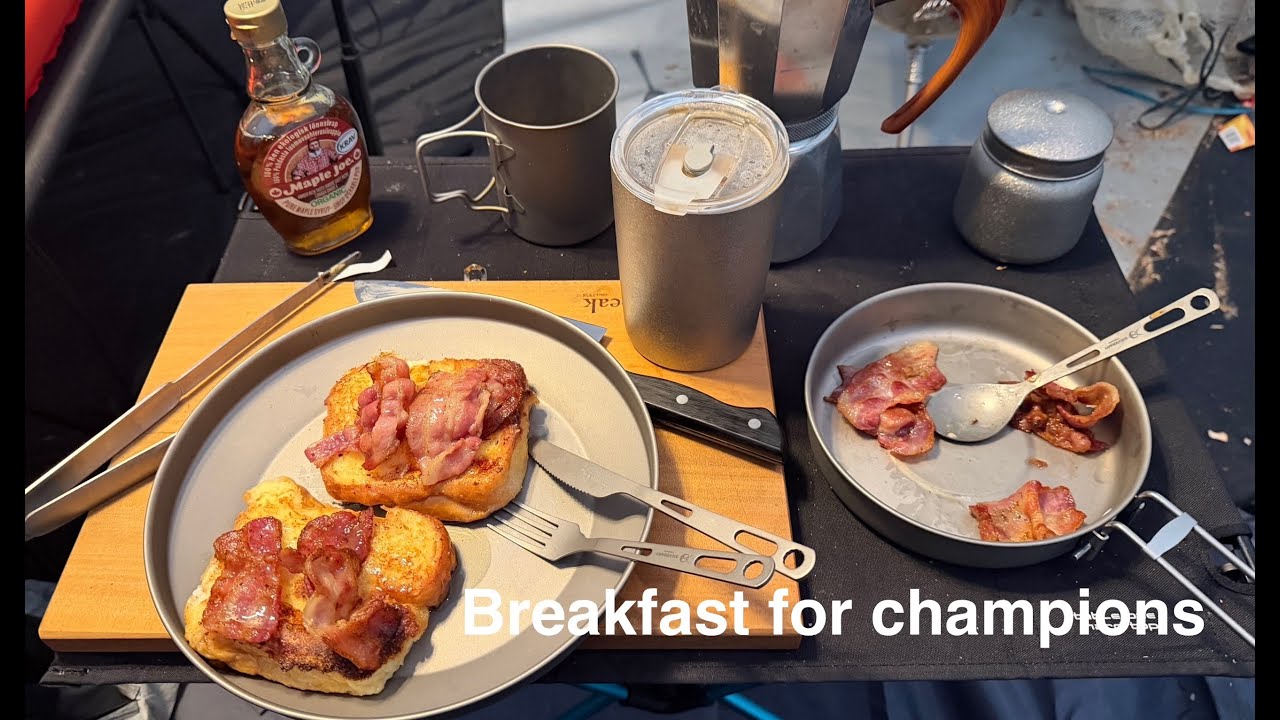 Now this is a breakfast while camping. French toast with bacon and maple syrup made on a wood stove.