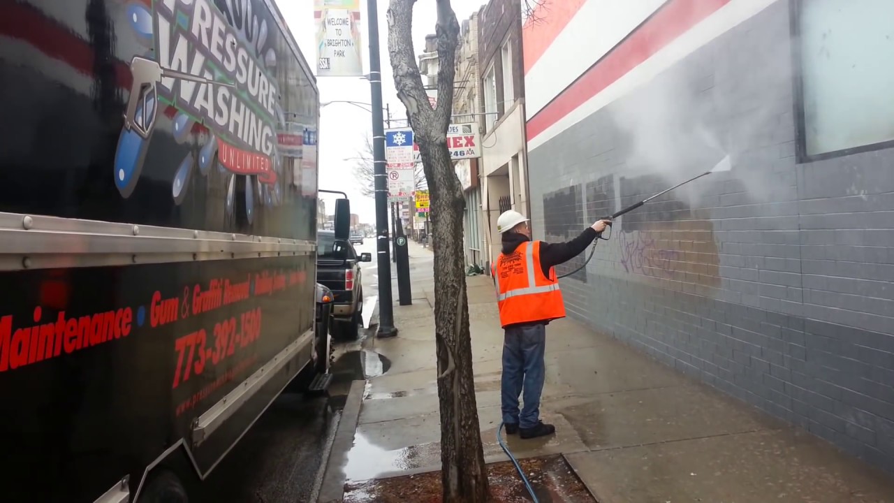 pressure washing graffiti off of auto zone store in chicago