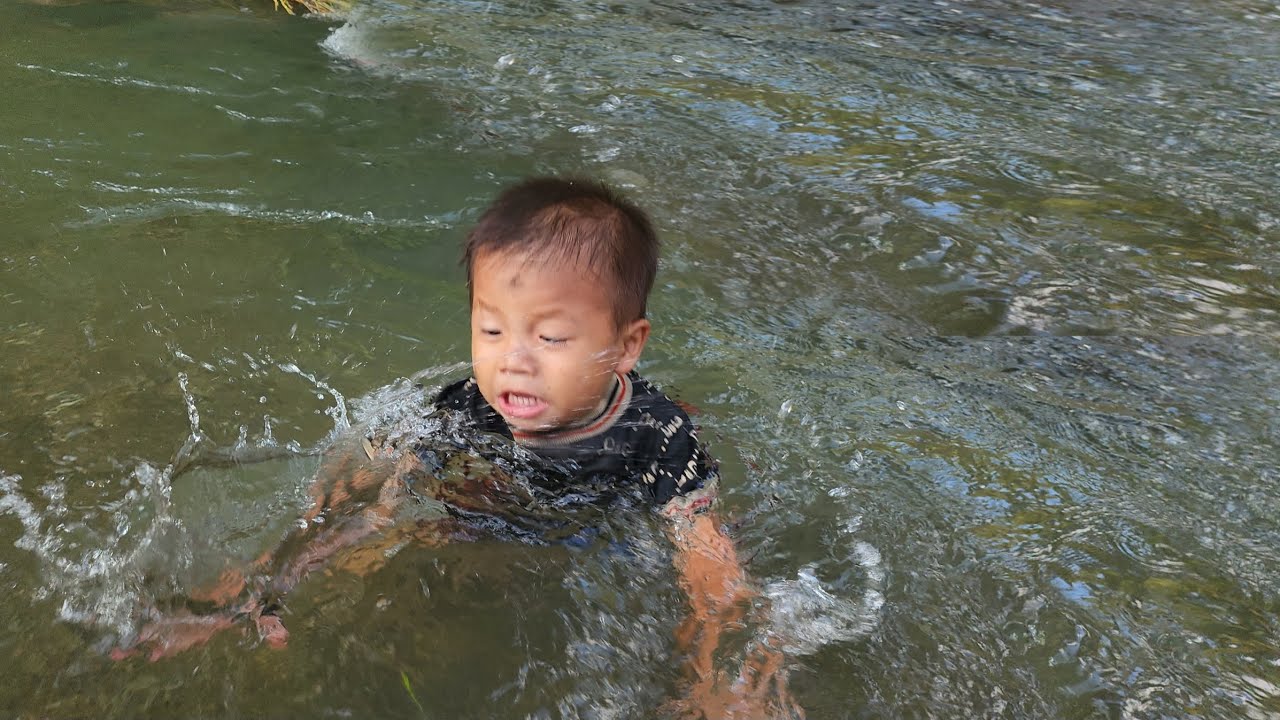 A single mother constantly searches for her lost son in the stream during flood season