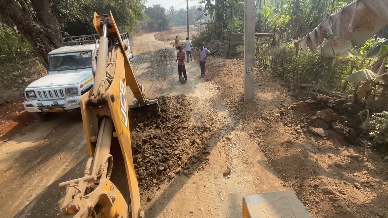 backhoe loader remove mud in road construction village road