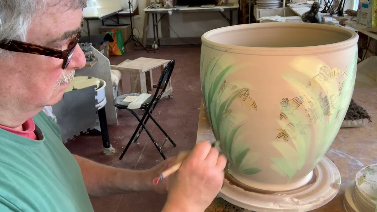 Painting with under glazes and using paper stencils.