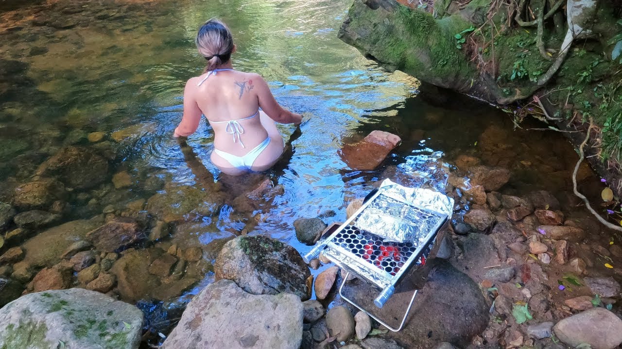 bathing in the river and preparing a delicious barbecue in nature - cooking outdoor