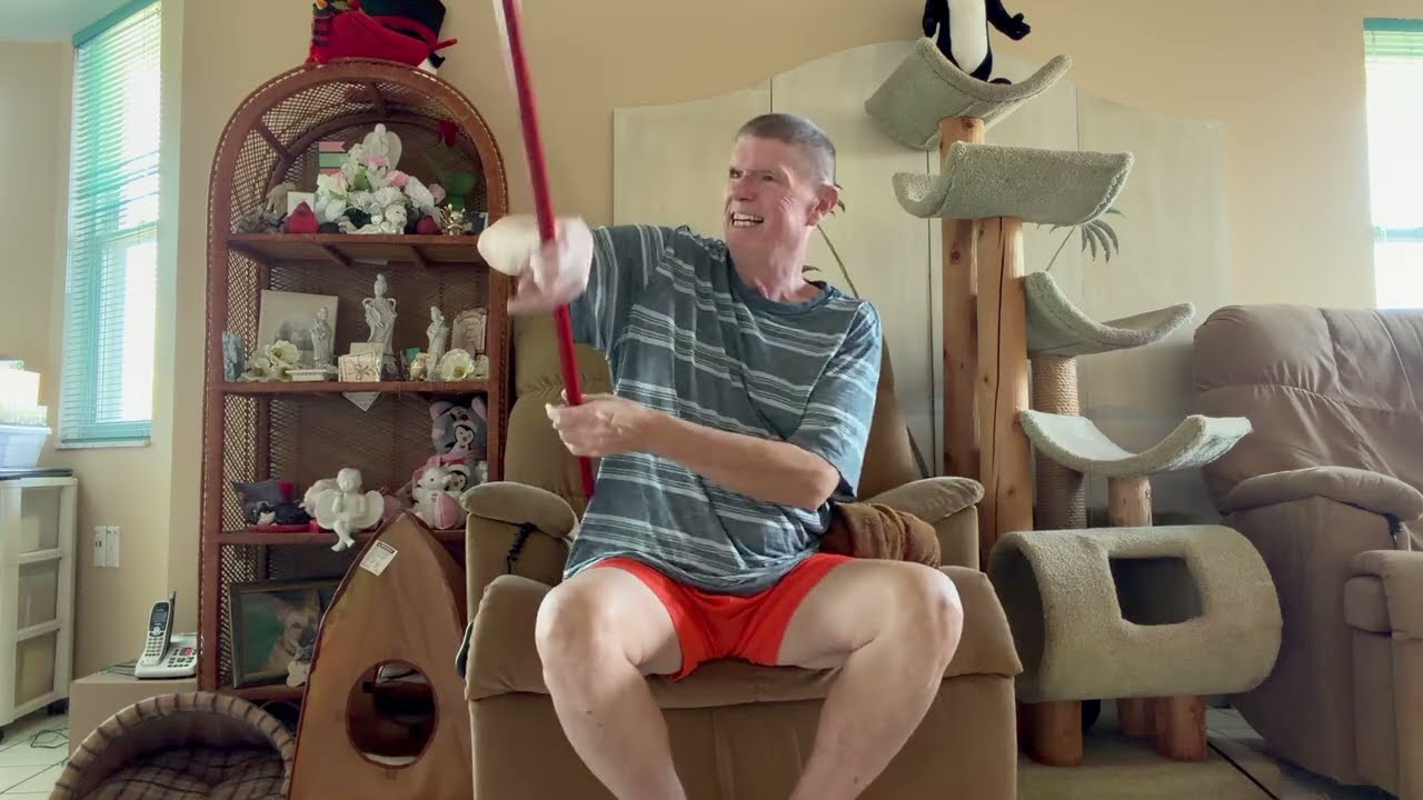 Seated Ex for Seniors with cane and towel. 