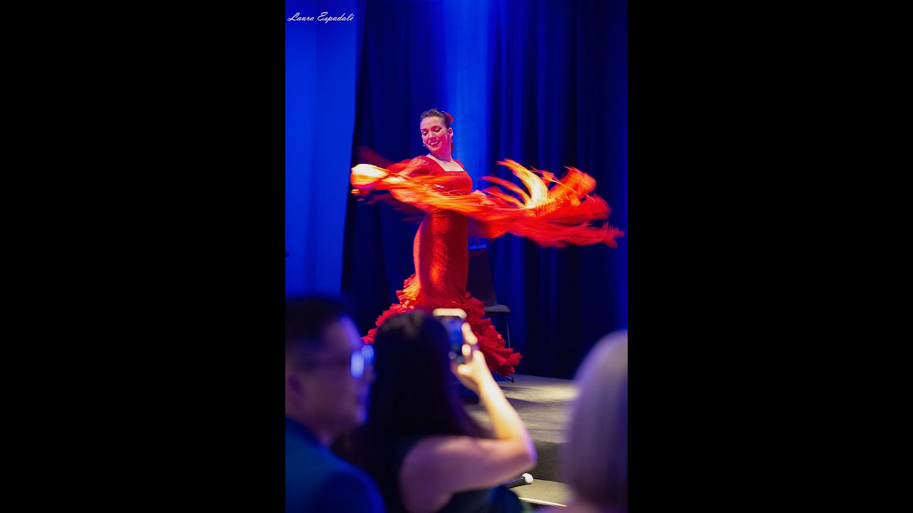 Flamenco dancer in flamenco dress with red tailed gown and shawl