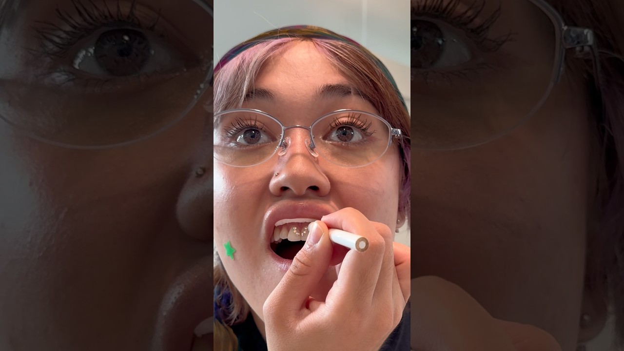 Giving myself a smiley piercing with tooth gems #sorryitsmari #smiley #toothgems #swarovski #diy