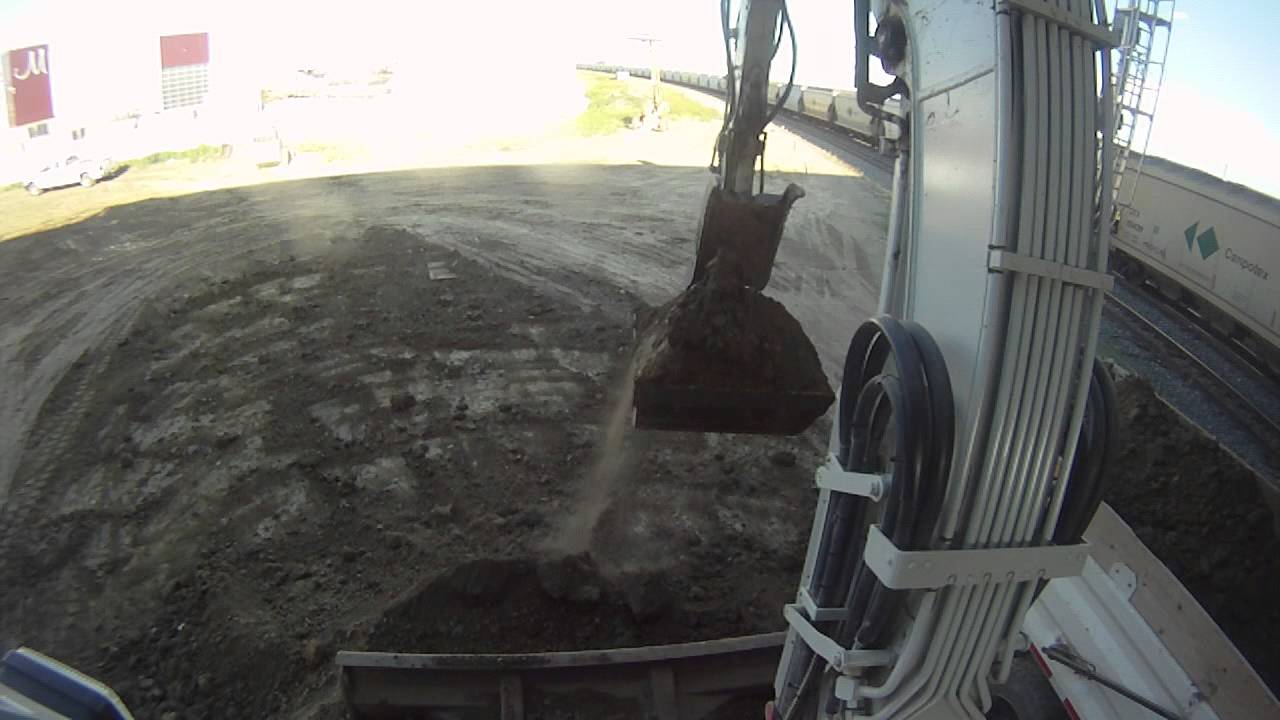 Takeuchi TB180 top of cab view loading a tandem truck.