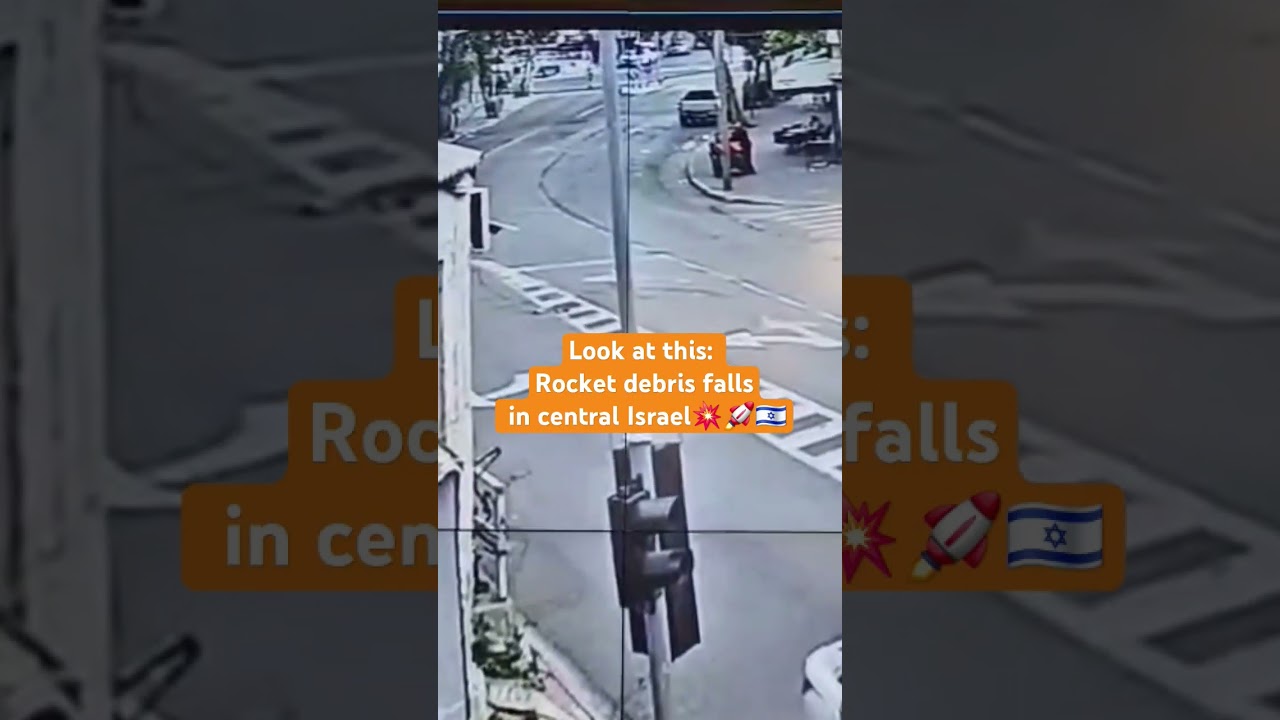 Moment rocket debris falls in central Israel &mdash; caught on camera 💥😲😲😲