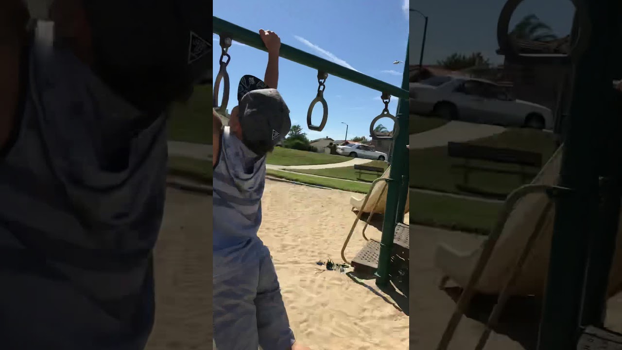 Kid doing tricks on monkey bars