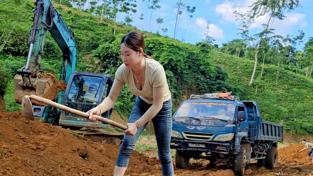 Girl finds excavator to level floor in preparation for new house