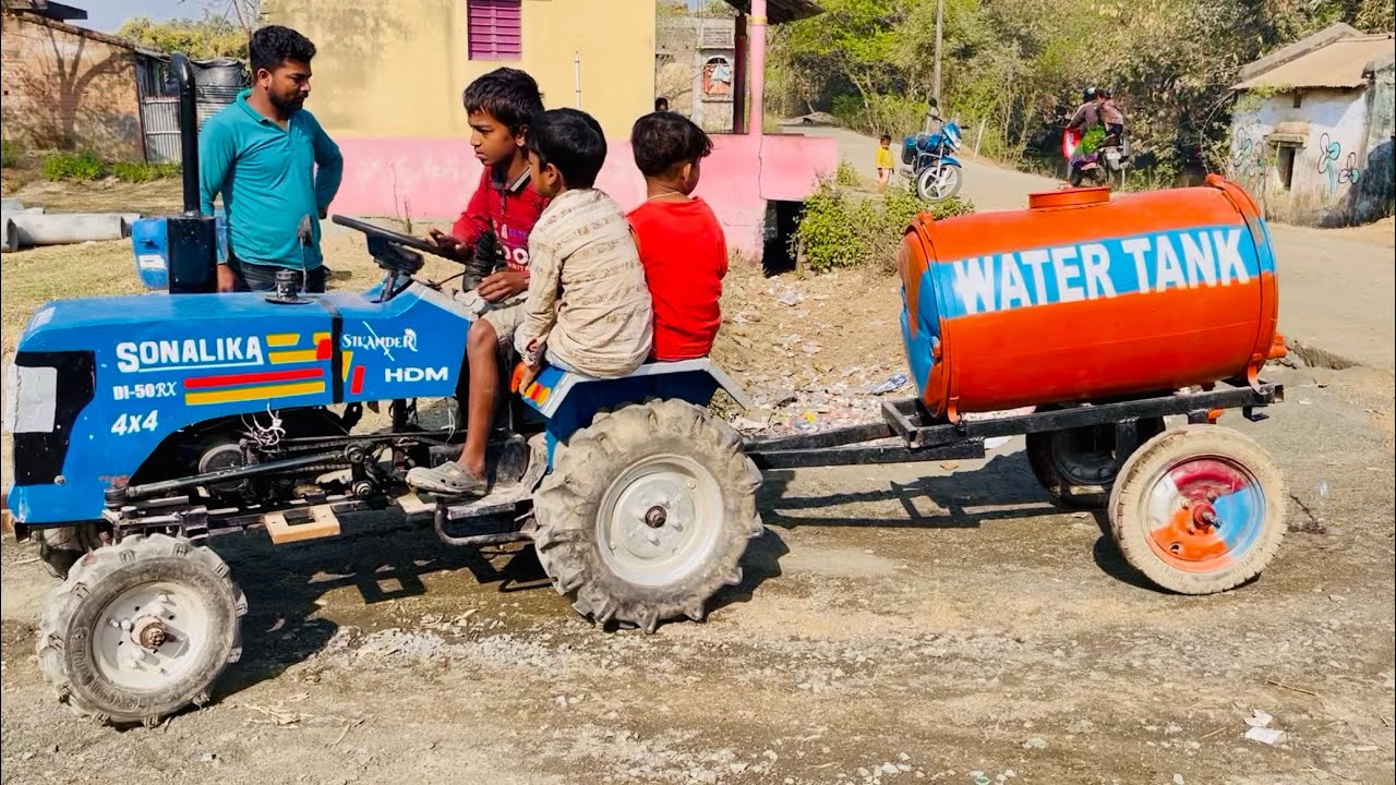 We are spraying water on the road with a mini Sonalika tractor (tractor video)