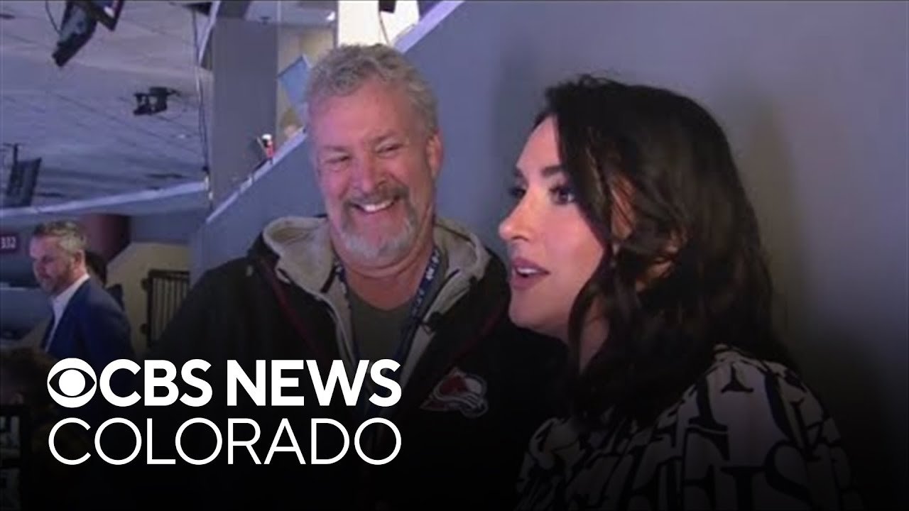 CBS Colorado's Romi Bean gets tips from Alan Roach, Avs PA announcer, at Ball Arena
