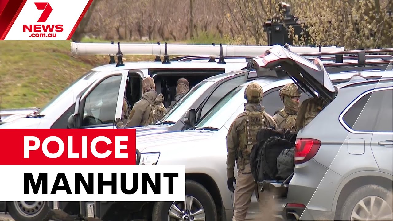 Manhunt continues for gunman after two police killed | 7NEWS