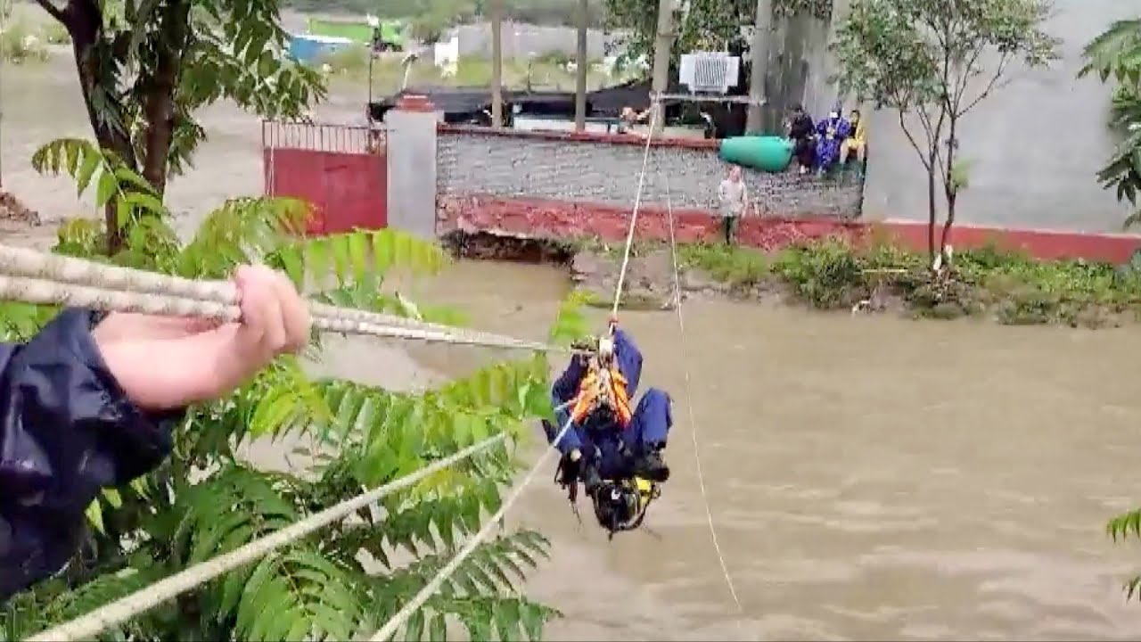 Firefighters rescue, evacuate people trapped by floods in Beijing