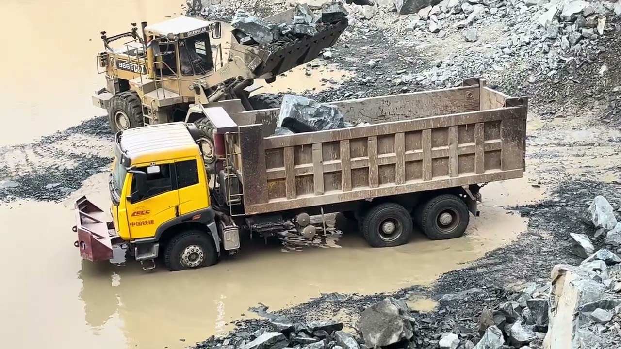 Raw Power in Action 💪Watch the Caterpillar 966F loading massive rocks with precision and strength.