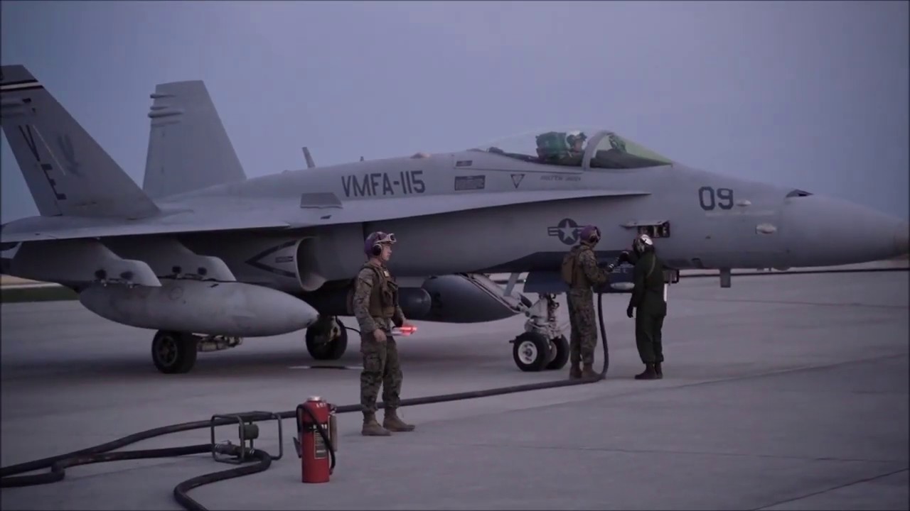 USMC F/A-18C Hornets hot refueling by KC-130J Super Hercules in Japan