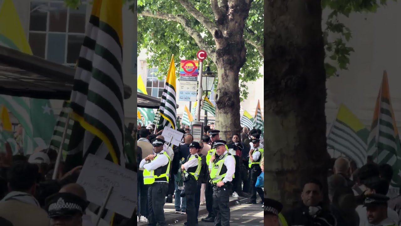 Free Kashmir protesters march through central London Whitehall Road past Downing Street