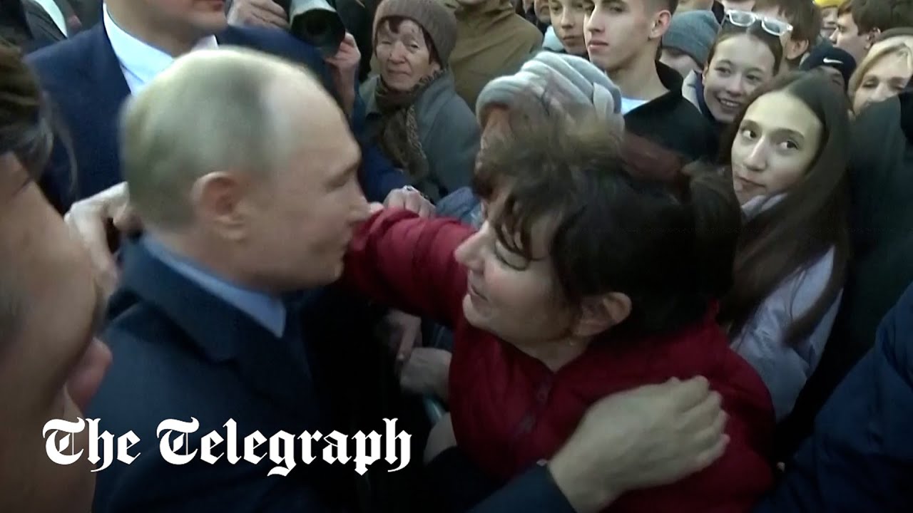 Putin kisses and hugs women during rare public interaction