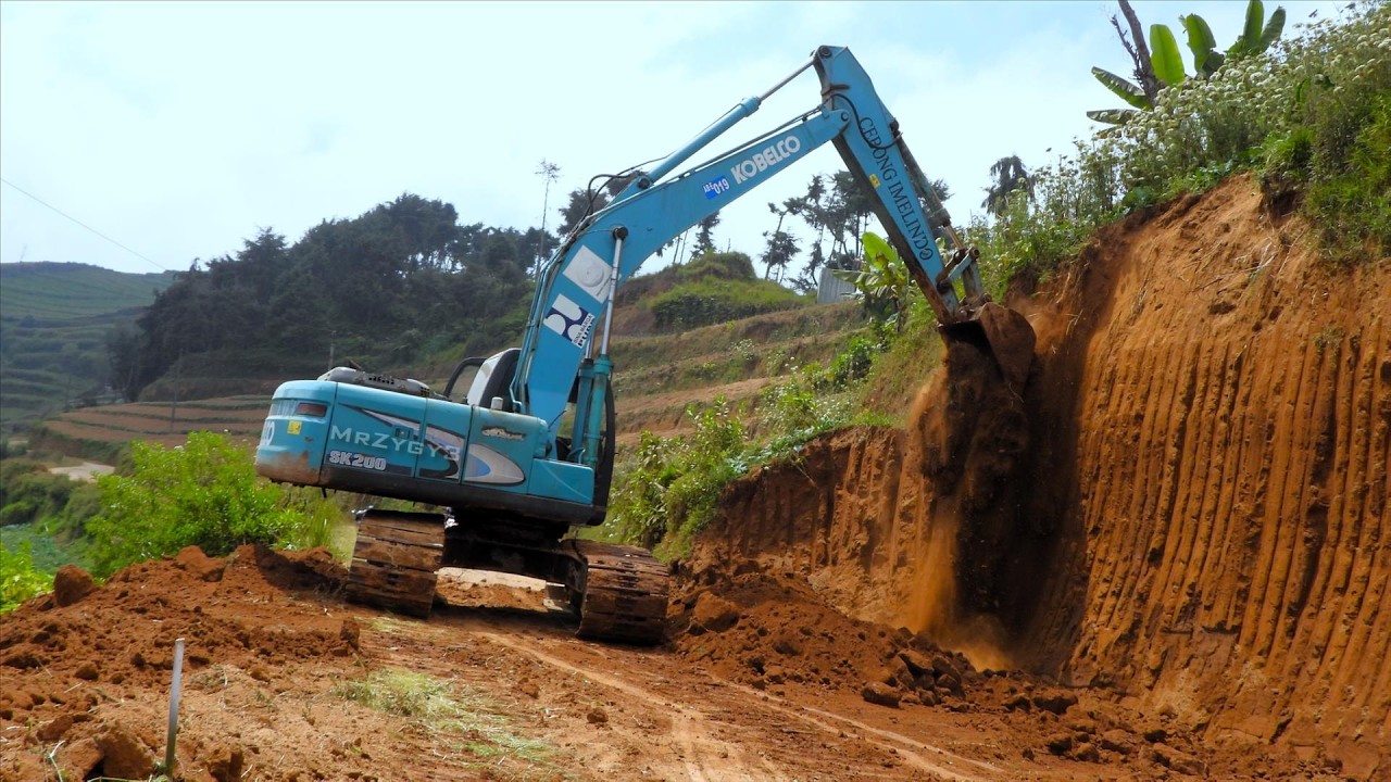 The Process Of Excavator Stripping Cliffs to Widen Mountain Roads