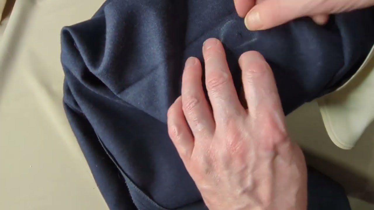 Repairing moth holes in trousers.Woth bespoke tailor and fashion designer JoJo Remeny