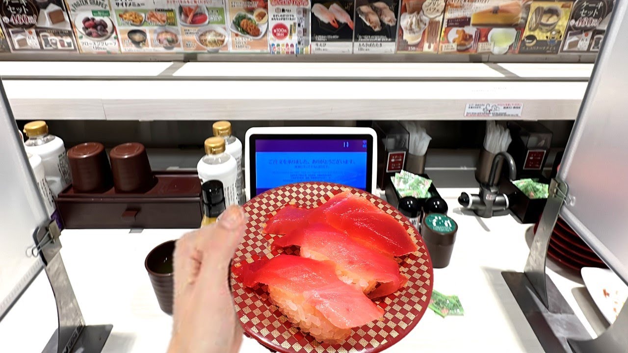 Eating at a Conveyor Belt Sushi Restaurant in japan |