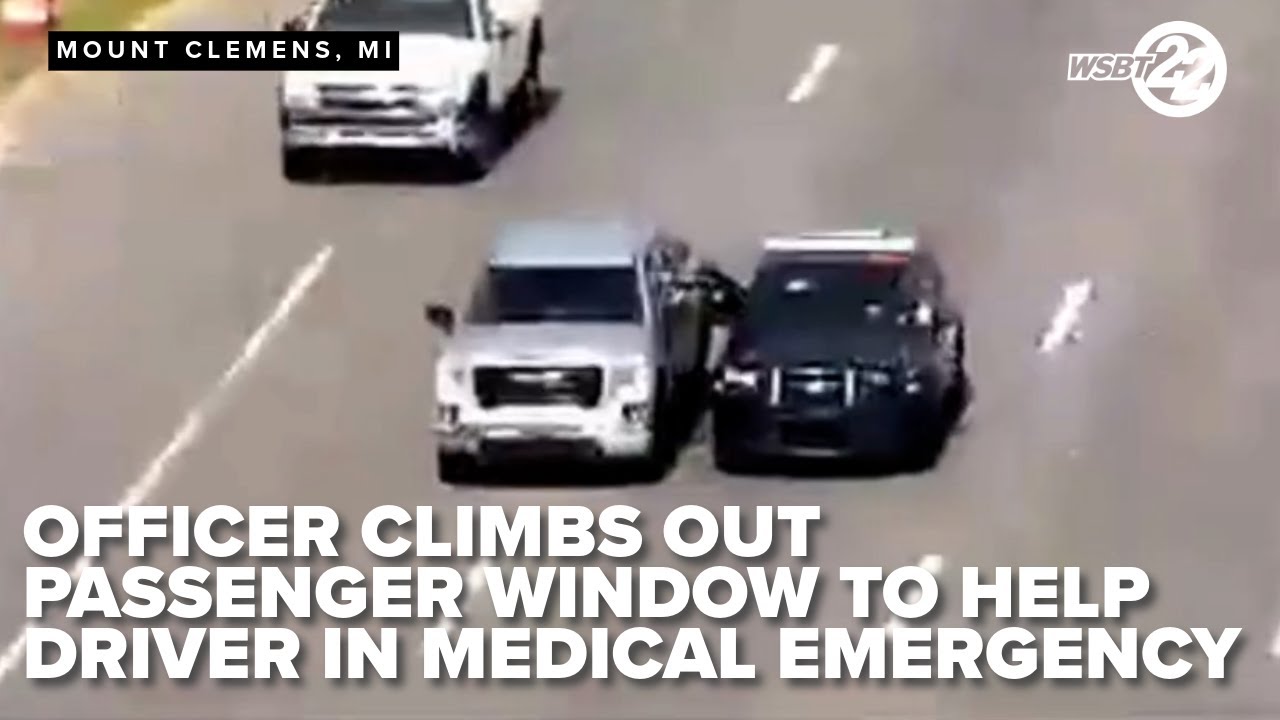 MUST WATCH! Officer climbs out of cruiser window to help motorist having medical emergency