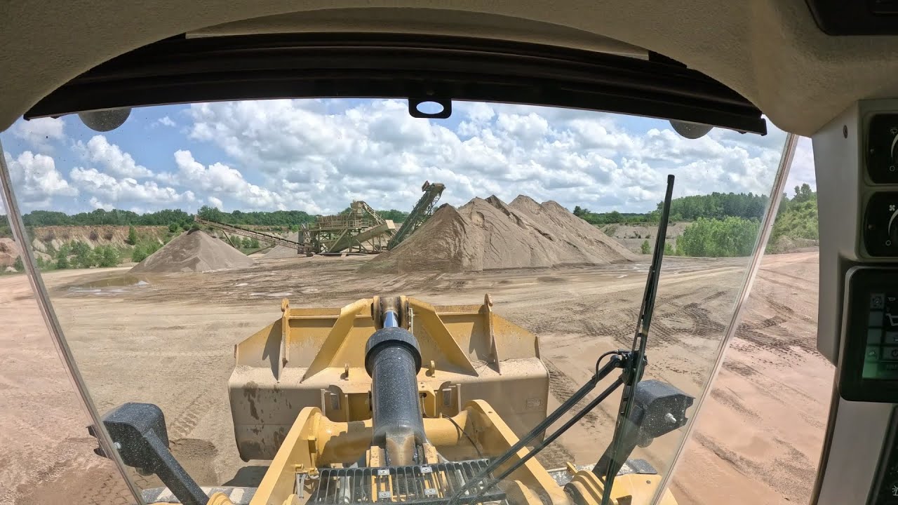 CAT 972M Pit mine operation, stockpiling and loading trucks.
