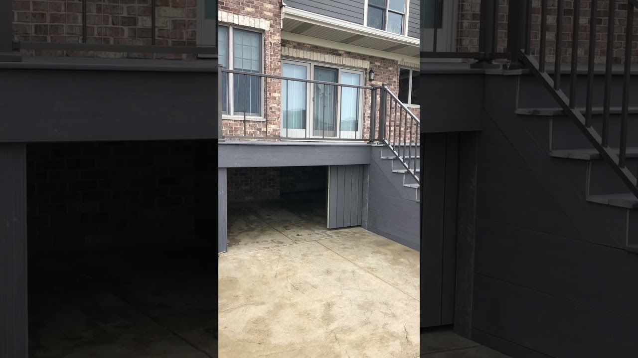 Barn door with concealed hardware for access to under deck storage