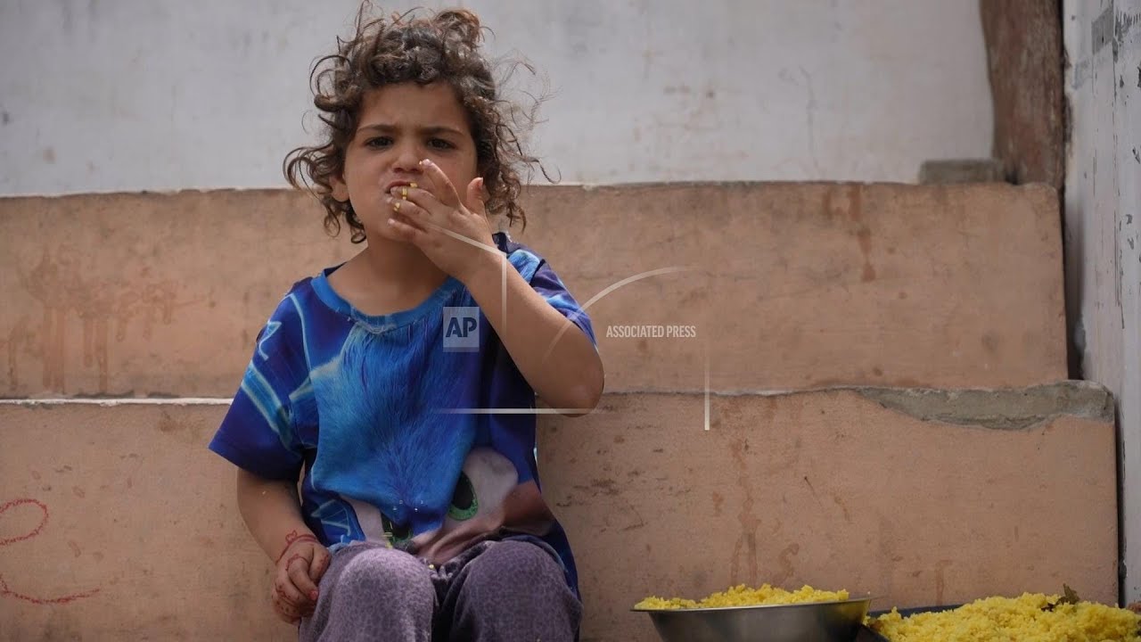 Palestinians wait in line for food at Gaza charity kitchen