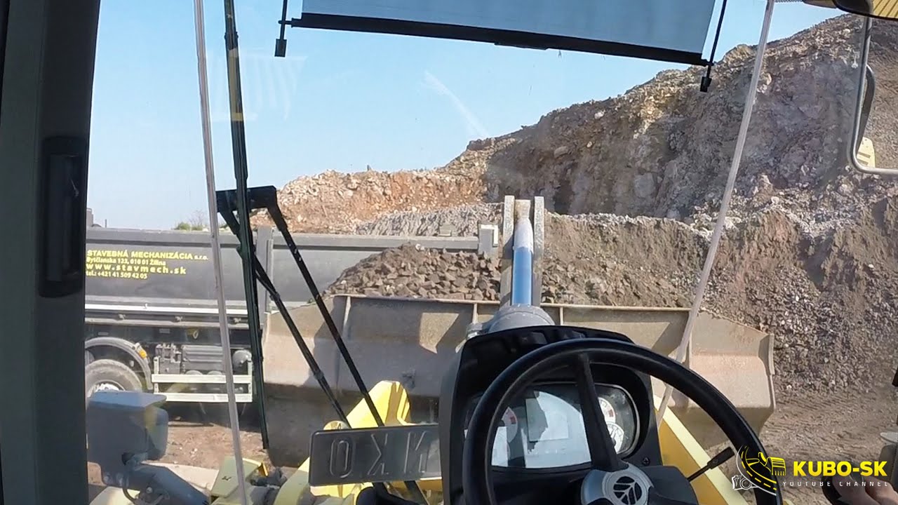 New Holland W190C wheel loader loading Volvo FMX truck - cab view