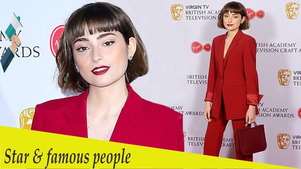 Poldark's Ellise Chappell goes braless in plunging trouser suit