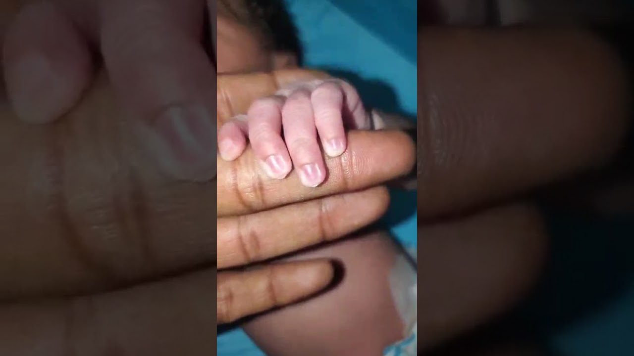 my newly born baby take the finger the doctor and full grap of it my newborn baby lot enjoyable