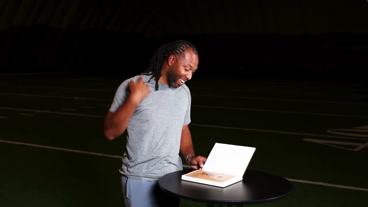 Flipping through history with Larry Fitzgerald 📖 #PFHOF #NFL #cardinals
