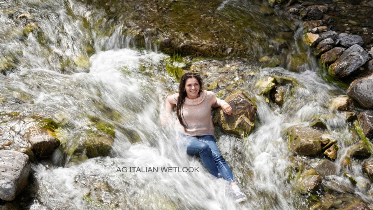 Wetlook - Leyla in river with blue Vans, socks, jeans and pink sweater (preview)