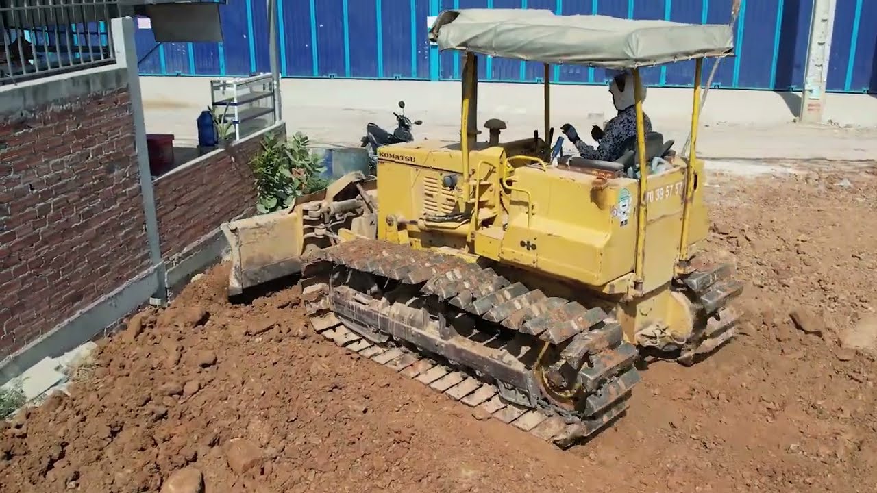 First Starting New project Showing Bulldozer working push soil filling up Dump truck 5T unloading.