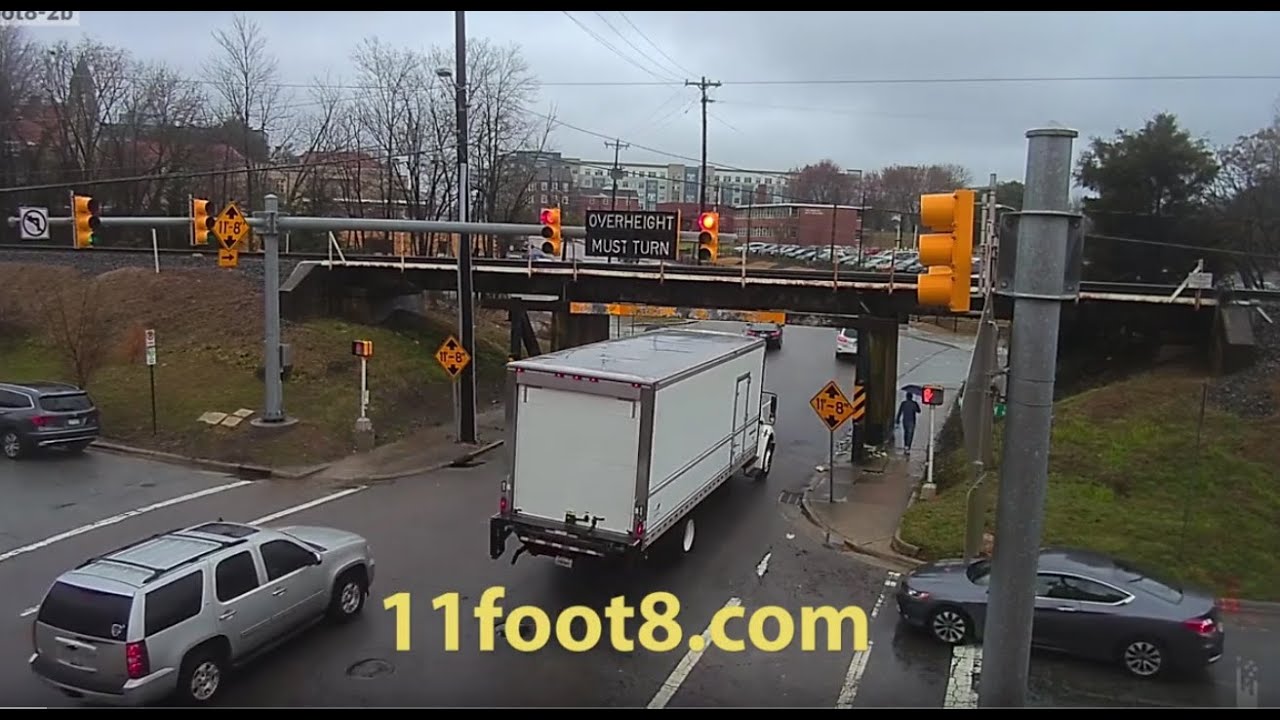 Pedestrian dodges truck crash debris at the 11foot8 bridge