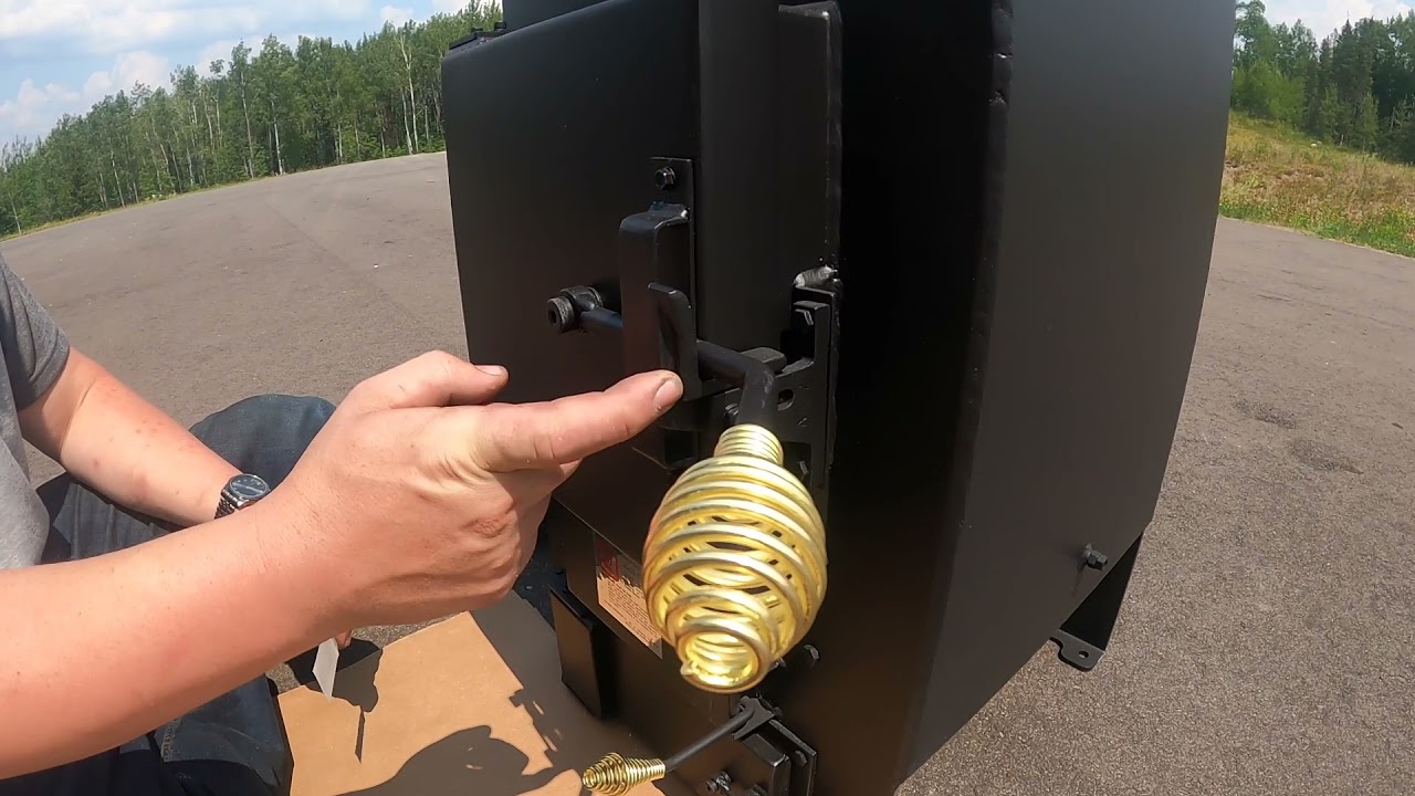 Adjusting the fire and ashpan doors on a Kuuma Wood-Burning Sauna Stove