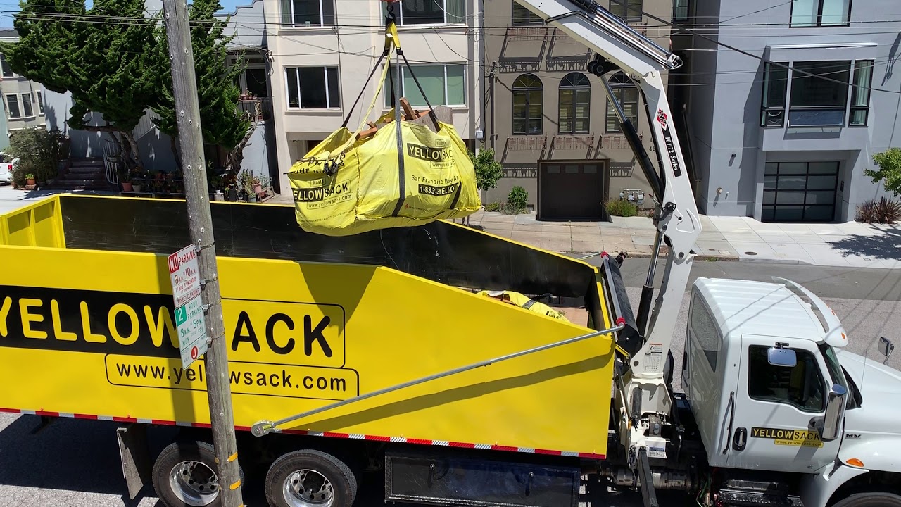 Yellowsack dumpster bags - crane truck picking up a Yellowsack with construction debris