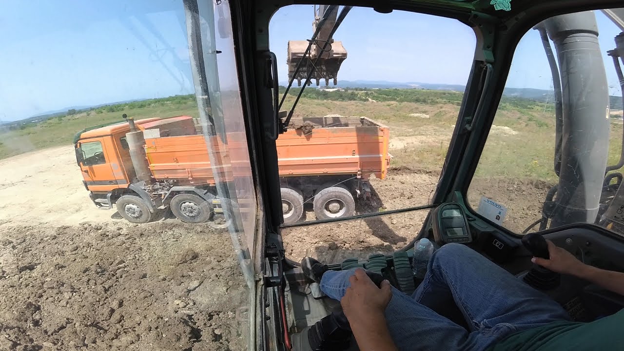 Excavator Volvo EC240B loads trucks #31