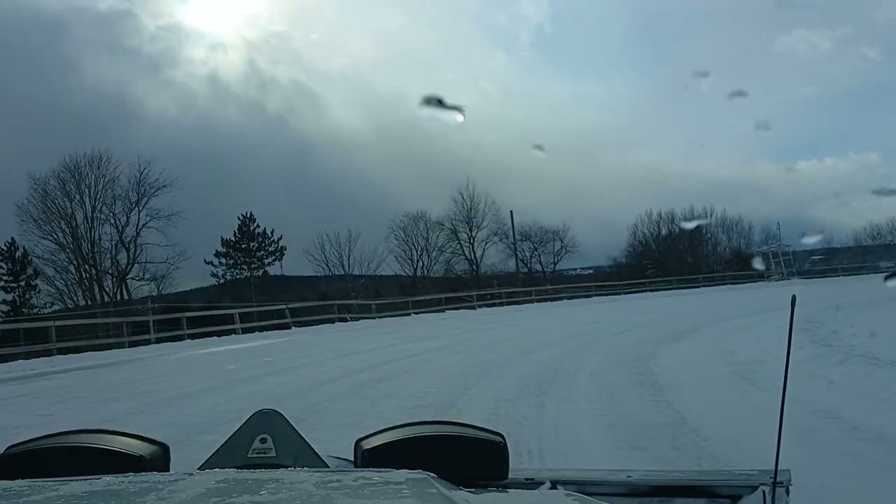Plowing the Woodstock,NB Ice Oval for Snowmobile Racing.