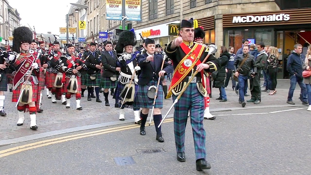 The Massed Highland Pipes & Drums marching through Inverness City centre in Scotland for Charity