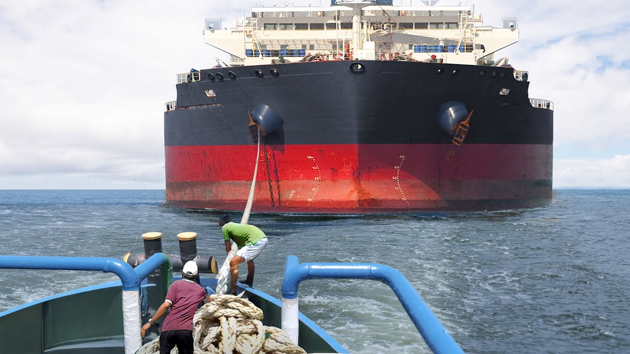 Day in the Life of a Tiny Tugboat Pulling Massive Ships at Sea