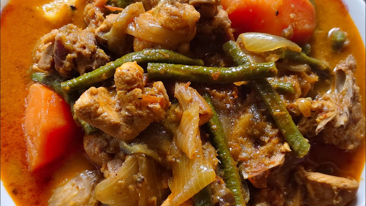 Making a delicious Khmer Chicken Curry (Somlar Kari) getting that vibrant, appetizing red color.