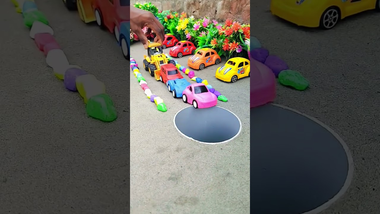 jcb pushing green purple pink blue and red car in pit 