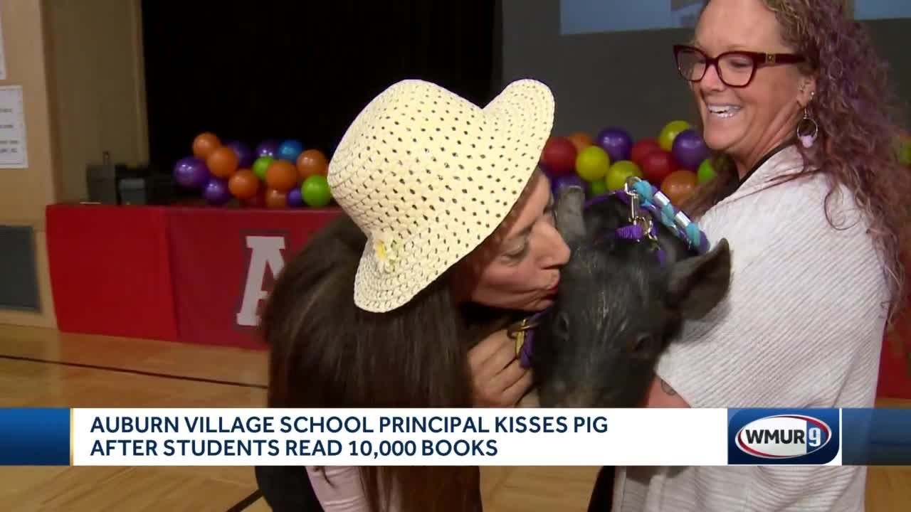 Auburn Village School principal kisses pig after students read 10,000 books
