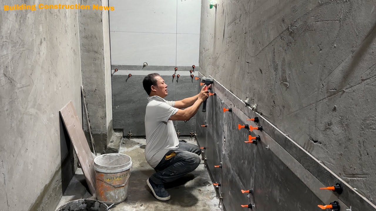 Craftsman Creativity Is Working Smartly In Installing Beautiful Ceramic Tile Bathroom Walls.