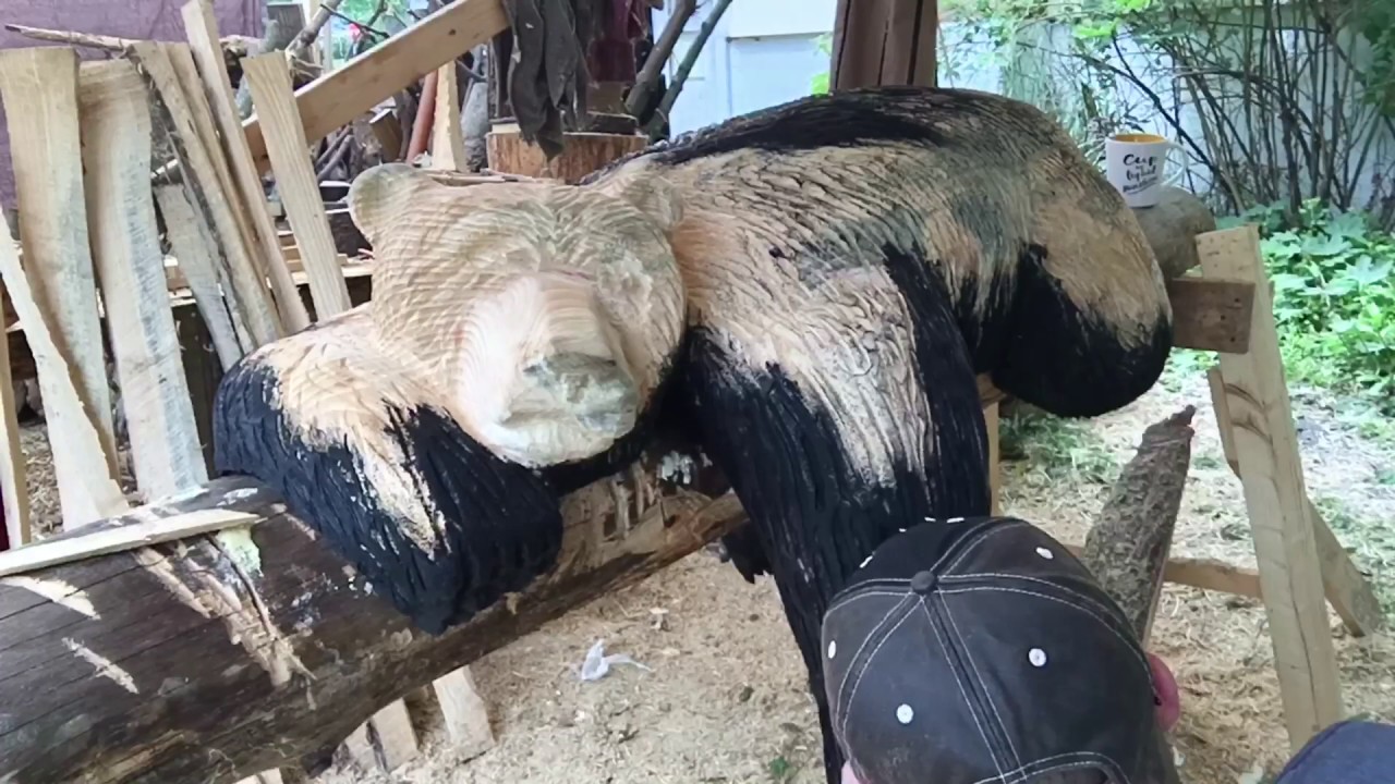 Chainsaw carving a bear sleeping on a log part 4