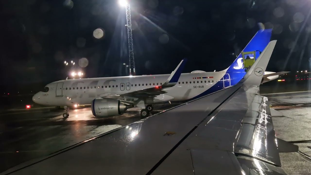 Flight take off at night  from Norway | De-icing solution being sprayed on Plane Wings seen | 4k UHD
