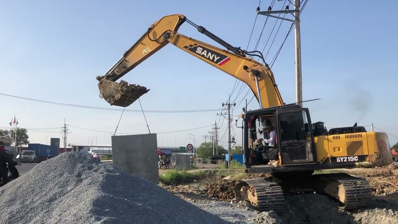 Excavator SANY Digging the ground to lay a drain for water