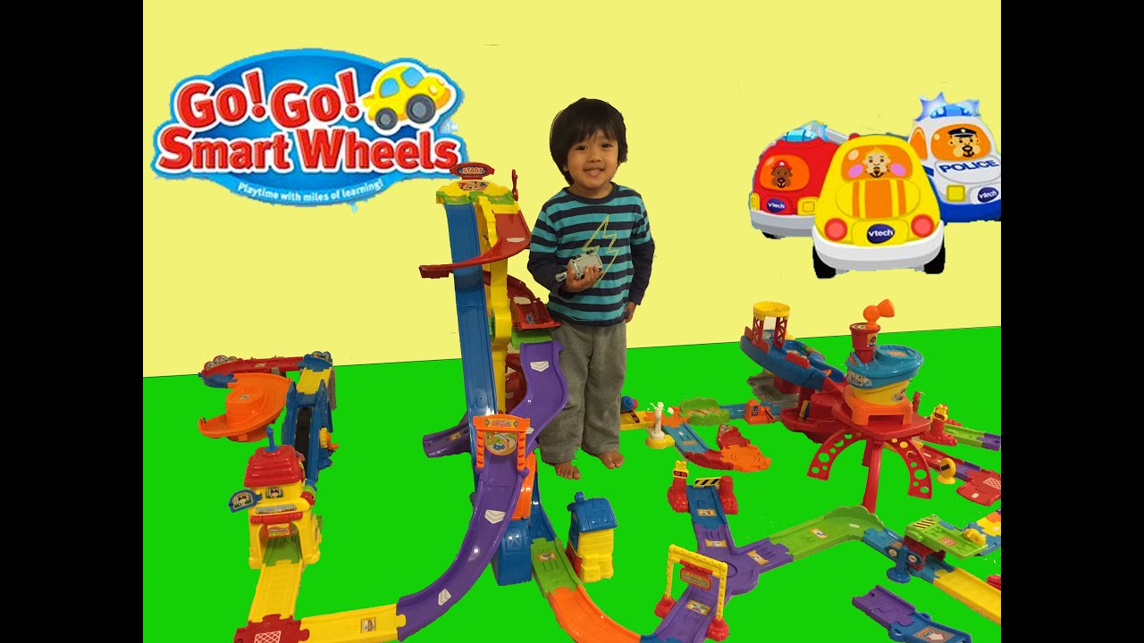 Kid playing with toys Vtech Go Go smart wheels toys
