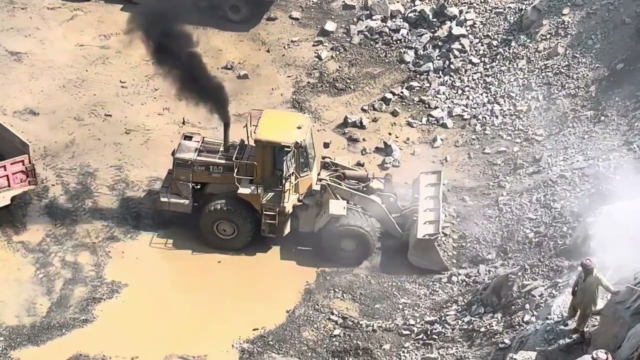 ۔Massive rocks loading with caterpillar machine heavy equipment in action